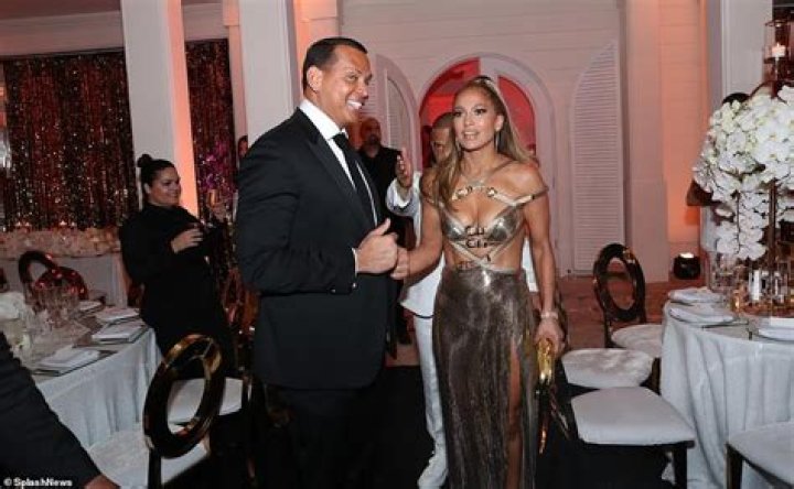 Jennifer Lopez Celebrates Her 50th Birthday Rockin’ a Stunning Gold Dress With Alex Rodriguez by Her Side