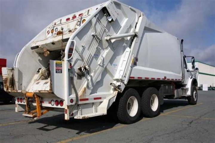 Why do garbage trucks have two steering wheels?